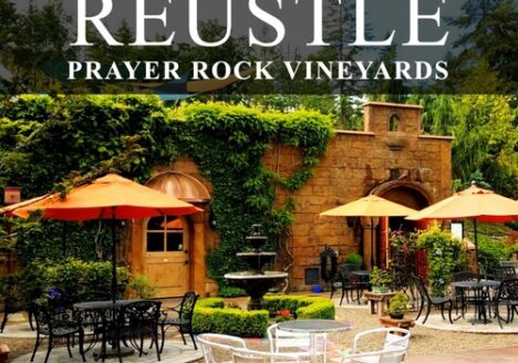 Reustle-Prayer Rock Vineayrds tasting room patio with banner of business name at top