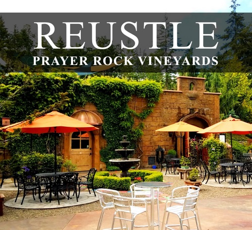 Reustle-Prayer Rock Vineayrds tasting room patio with banner of business name at top